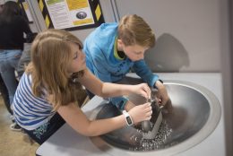 Visitors playing with magnets