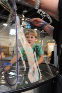 Child Making Large Bubble