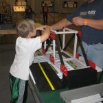 Child Playing With Truss Bridge