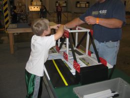 Child Playing With Truss Bridge
