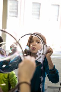 Child Playing With Lancster Science Factory Exhibit