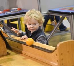Child playing with ball exhibit