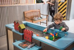 Kid playing at the water lab in the hydrodam. Learn about our hours!